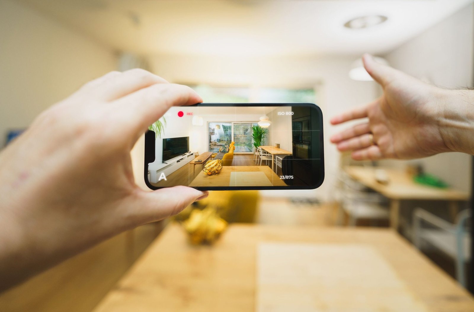 Interactive virtual tour of a contemporary living room using a smartphone.